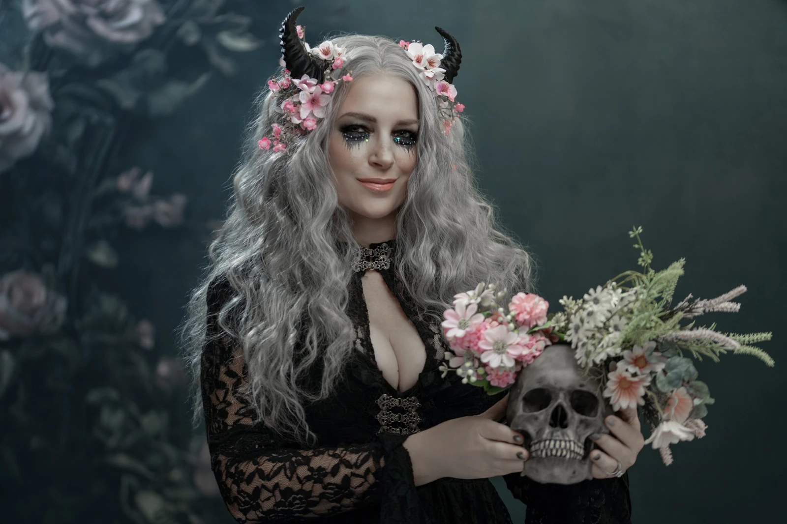 Woman holding a flower-filled skull against the Victorian Gothic Frame with Flowers backdrop
