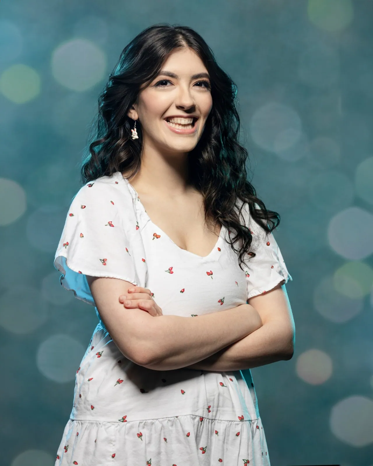Boom-mounted light shaping a blue-background portrait — finished portrait