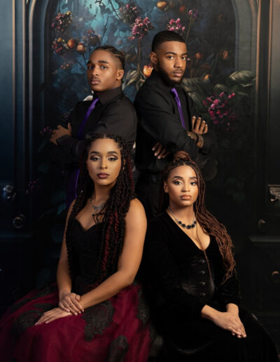 Large family posed together in coordinated black and purple formalwear.