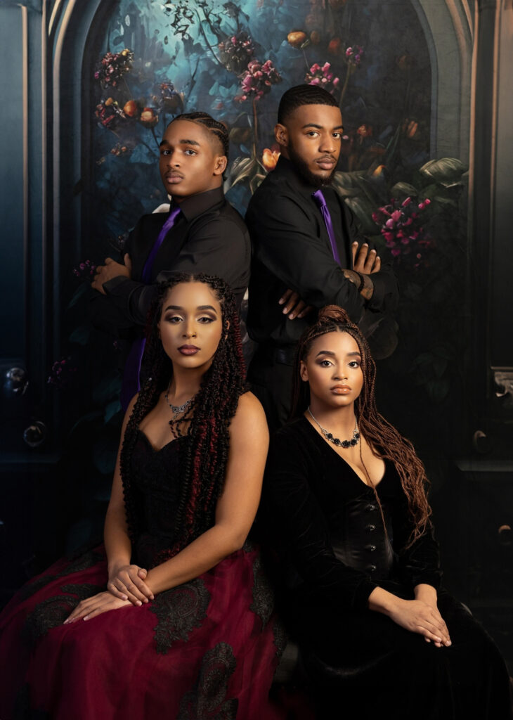 Large family posed together in coordinated black and purple formalwear.