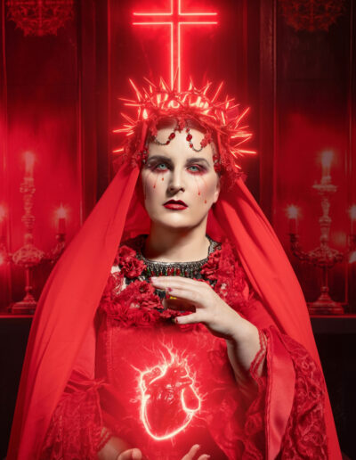 Dramatic red religious fantasy portrait illuminated by a glowing neon cross