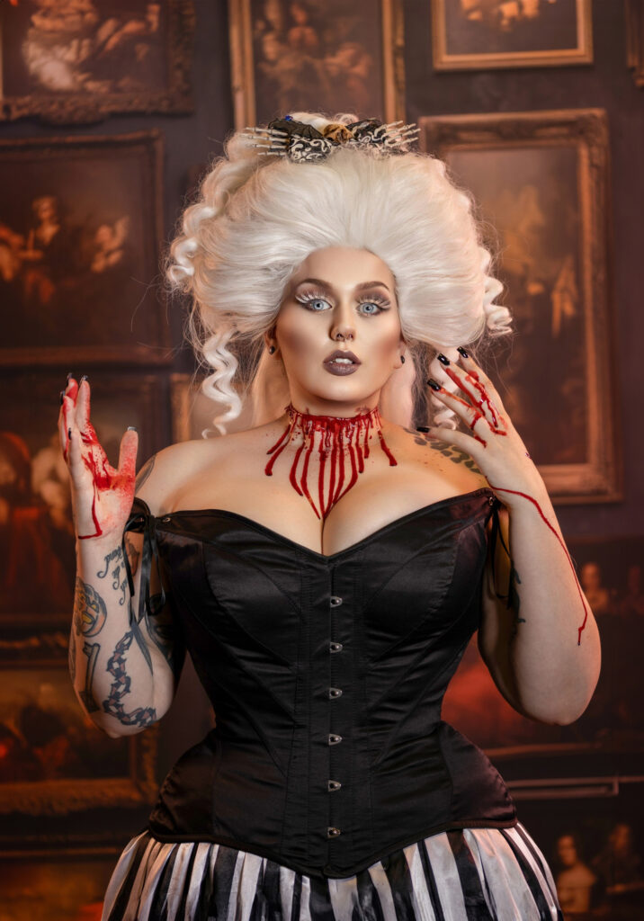 Vintage-inspired white-haired woman wearing a black corset and red statement jewelry