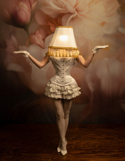 Surreal fine art portrait of a woman transformed into a glowing table lamp