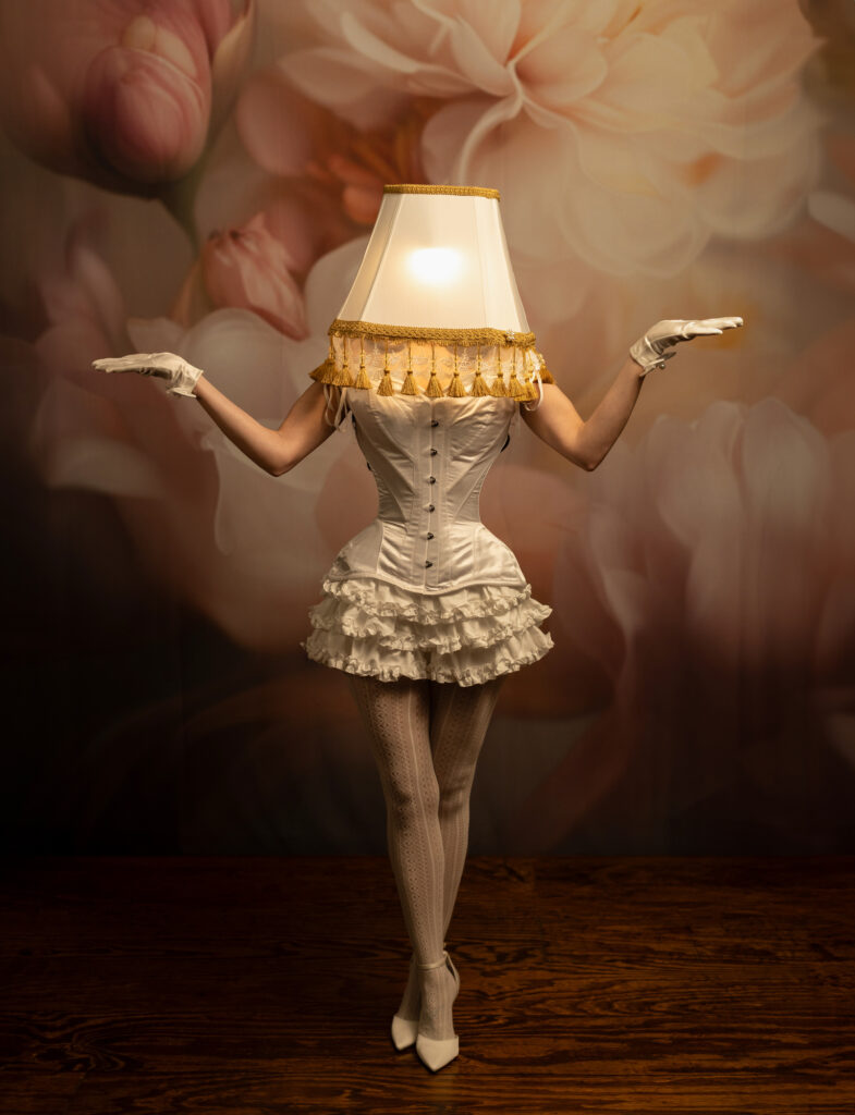 Surreal fine art portrait of a woman transformed into a glowing table lamp