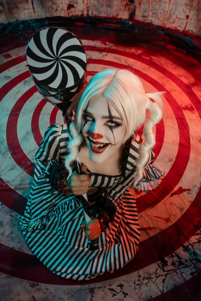 Sinister carnival clown in a striped costume against a hypnotic backdrop