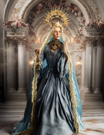 Regal fantasy woman in a blue gown beneath an ornate cathedral arch