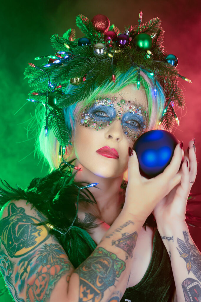 Green fantasy character holding a luminous blue orb in an enchanted setting