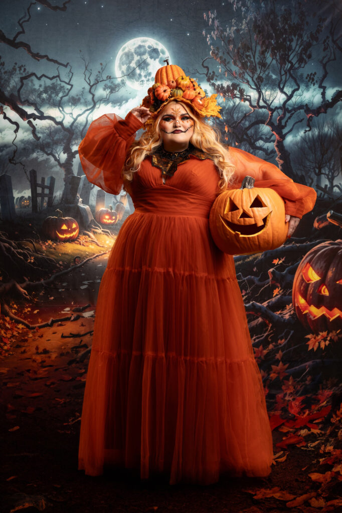 Halloween fantasy portrait of a pumpkin queen in a flowing orange gown