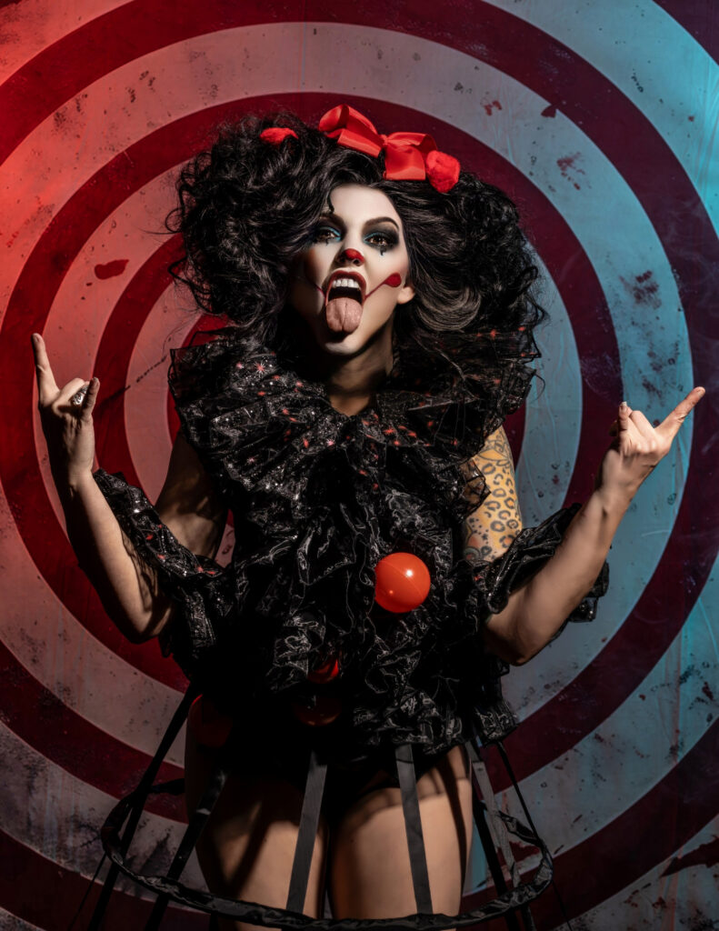 Dark circus portrait with a black-and-red costume and target backdrop