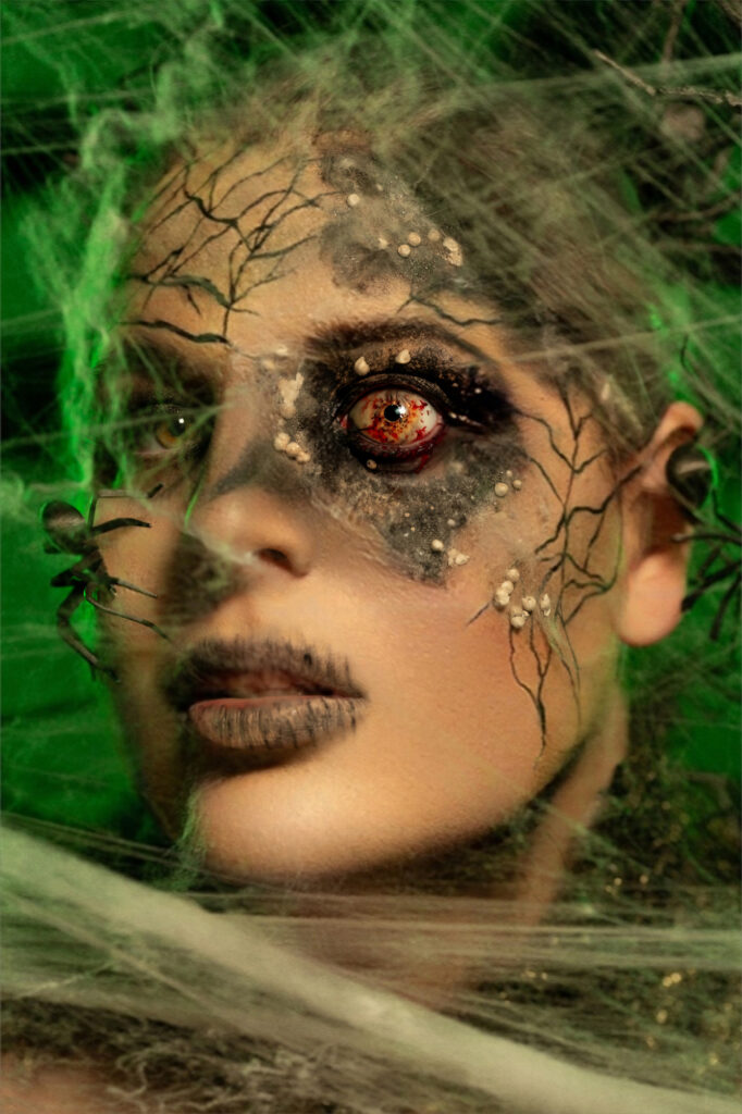 Close-up portrait of a moss-covered woodland creature with an amber eye