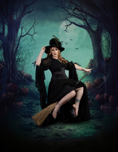Classic witch in a pointed hat seated beneath a moonlit sky