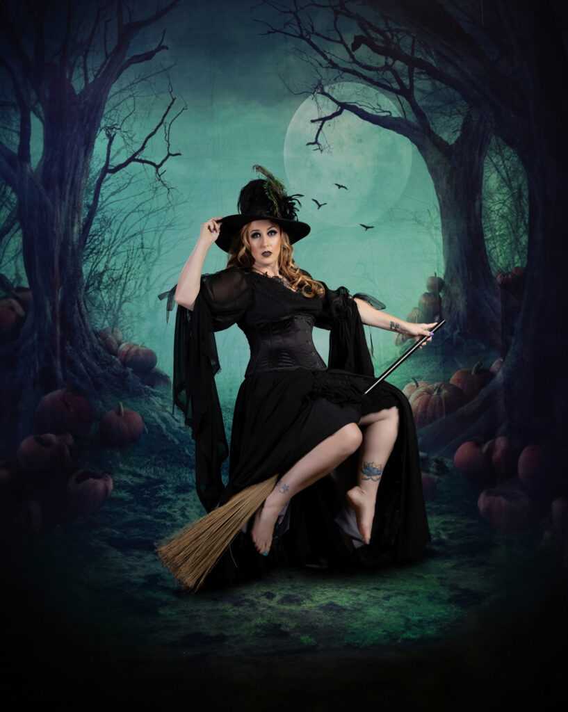 Classic witch in a pointed hat seated beneath a moonlit sky