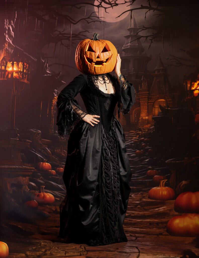 Pumpkin-headed figure standing in a dark candlelit Halloween setting