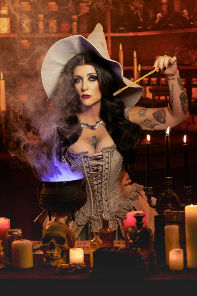 Sultry witch in a corset and pointed hat surrounded by warm candlelight