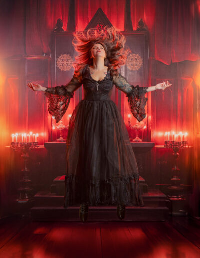 Dramatic gothic woman in a flowing black-and-red gown
