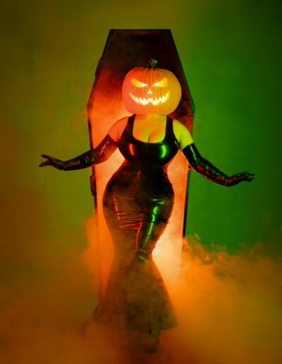 Pumpkin-headed Halloween character illuminated by green and orange light