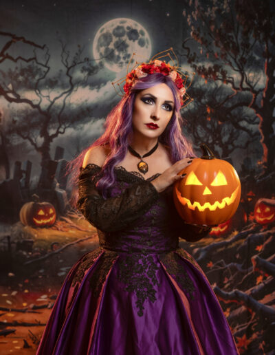 ed-haired Halloween witch holding a glowing jack-o’-lantern