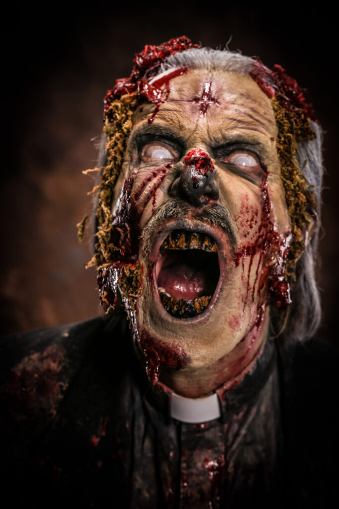 Snarling horror creature with distressed skin, sharp teeth and gruesome special-effects makeup.