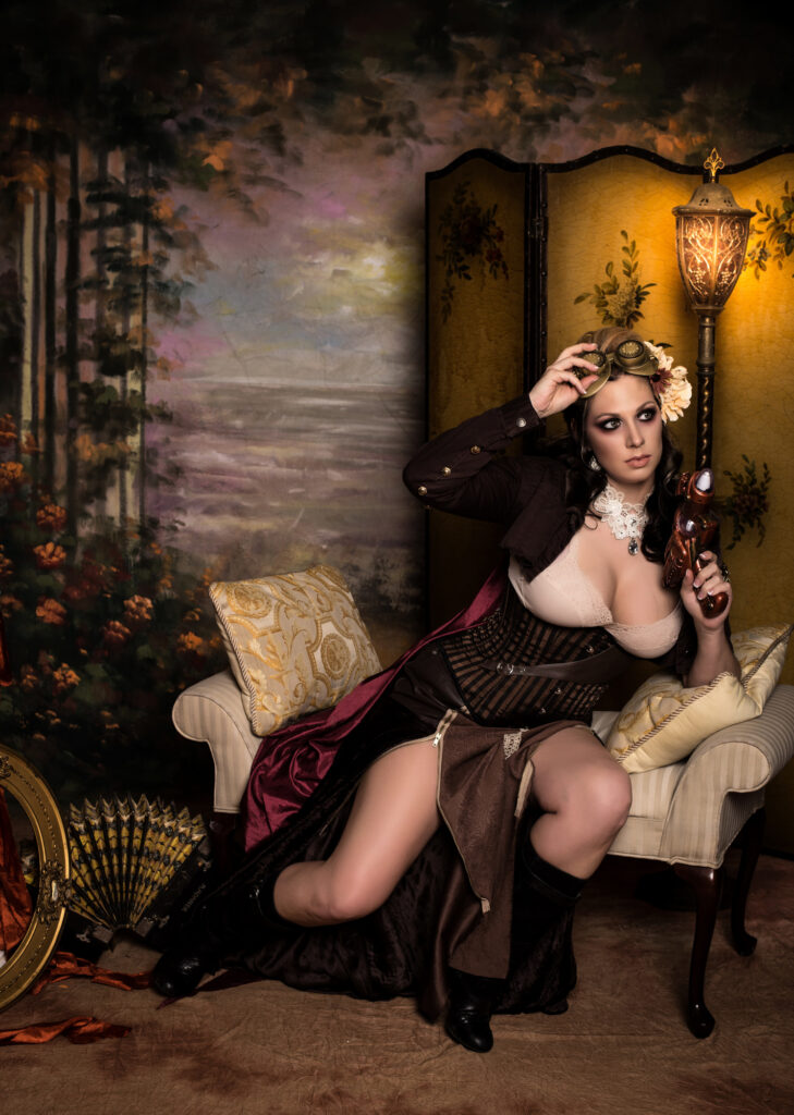 Steampunk woman in a brown corset and burgundy skirt seated in a vintage parlor.